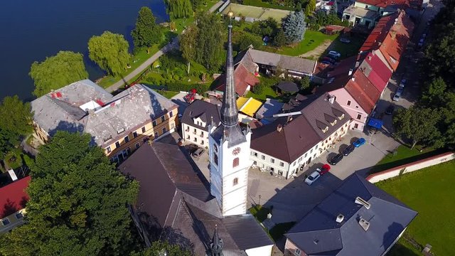 Aerial footage of the town of Frymburk including the Church of Saint Bartholomew, located in south bohemia, Czech Republic.