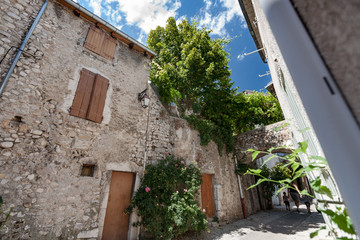 Authentic French town with narrow streets, colorful houses and atmospheric flowers.