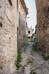 Fototapeta na wymiar Authentic French town with narrow streets, colorful houses and atmospheric flowers.