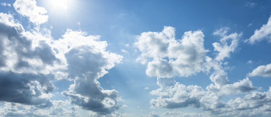 Blue sky with clouds and sun