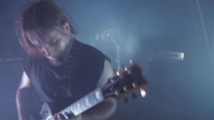 Concert rock band performing on stage with Frontman, guitarists and drummer. Music video punk, heavy metal or rock group.