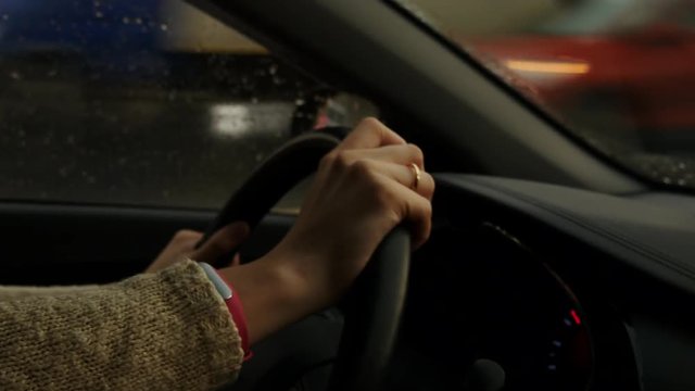 Woman Hands On Steering Wheel Of A Car In Rainy Weather