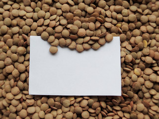 Closeup of White tag on raw lentils background