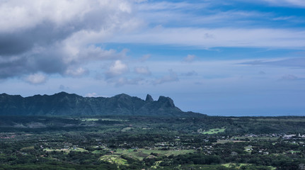 View of a valley and Kong Mountain, with a dramatic, cloudy sky, on the Nounou trail, towards Sleeping Giant, on Kauai - 169766845