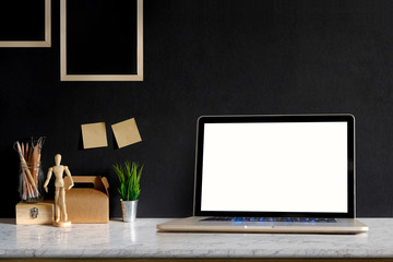 Mock up Laptop on Marble table with Blank screen laptop, Molding or Craft tools, pencils and houseplant. desk workspace with copy space for products display montage.