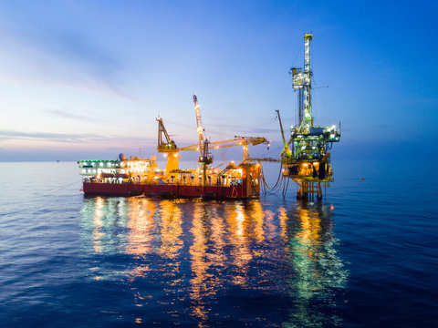 Aerial View of Tender Drilling Oil Rig (Barge Oil Rig) in The Middle of The Ocean at Night