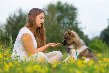 woman plays with her labrador retriever in a lake