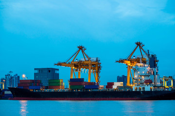 Fototapeta premium Shipping trade port. Container cargo ship loading or unloading by crane bridge. Logistics industrial and transportation business background