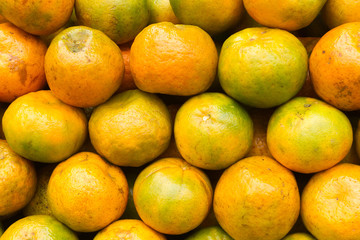 Pile of fresh tangerines ready to sell in the supermarket