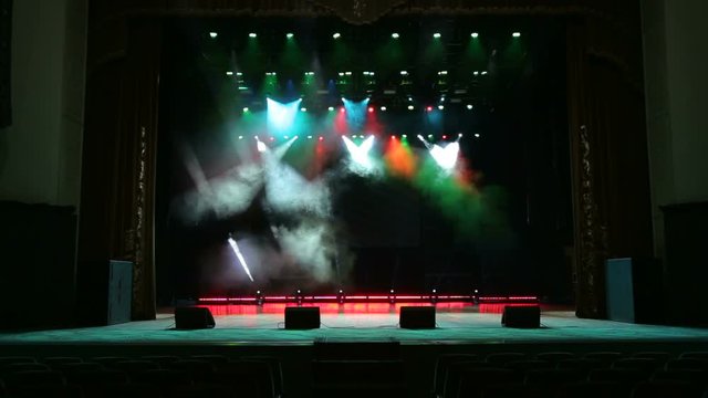 Stage lights with smoke on concert. Background in show. Stage lights and smoke. Colored lights on an empty concert stage with smoke.
