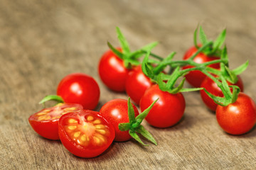 Fresh cherry tomato on rustic wood table. Close up lovely cherry tomato for background or wallpaper. Prepare fresh cut cherry tomato for home cooking look so delicious. Macro concept with copy space.