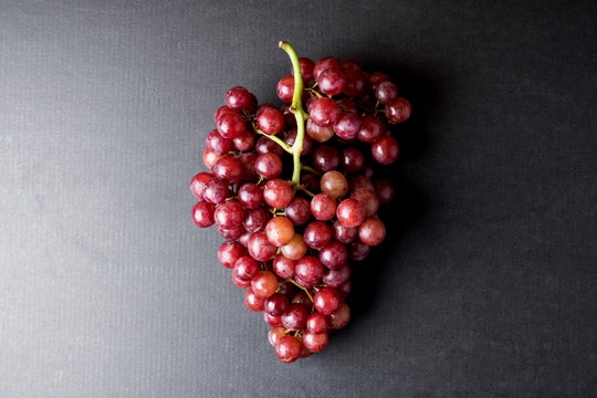 Top View Of Red Grapes On A Black Background.