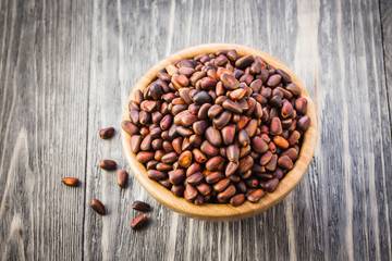 Pine nuts on wooden background. Top view, copy space.