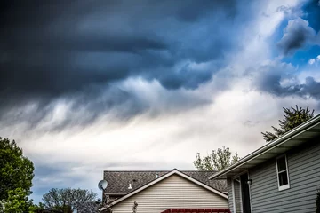 Poster Thunderstorm clouds over suburban houses © soupstock
