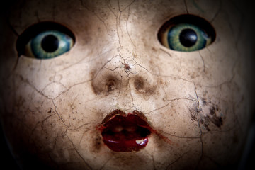 Scary cracked old doll face
