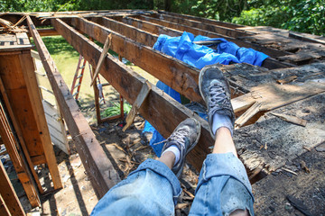 Person resting while tearing down an addition on a house