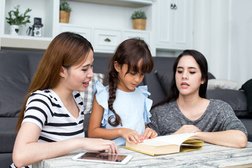 Happy family woman and kid reading book at home, happy family concept, 3 person