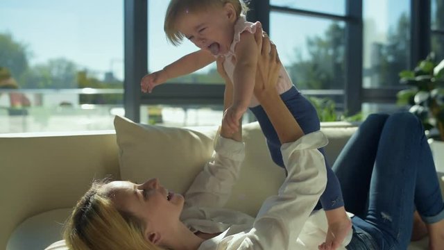 Optimistic mother playing with the child