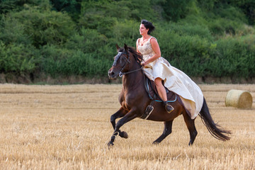 mature woman riding an Andalusian horse