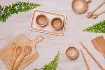 Set of kitchen utensils on vintage planked wood table from above, wooden background