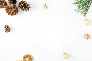 Frame of fir branch, pine cones, dry orange, Christmas balls