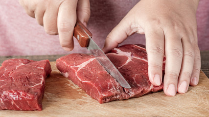 Cutting meat on a board