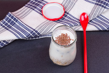 Healthy breakfast - yogurt with blueberries and muesli served in glass jar