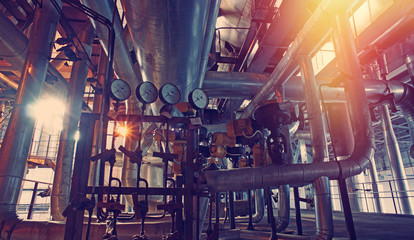 Equipment, cables and piping as found inside of a modern industrial power plant