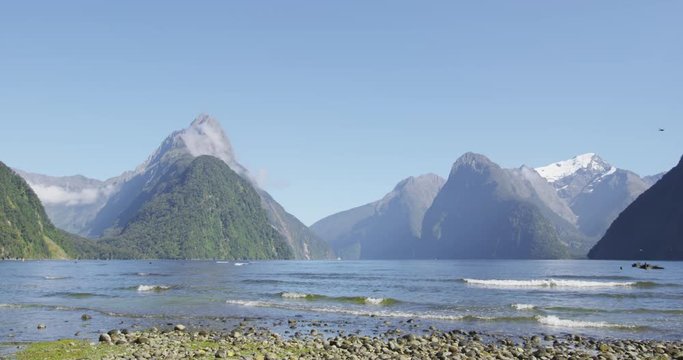 New Zealand tourist destination Milford Sound and Mitre Peak in Fiordland National Park, New Zealand. Iconic and famous New Zealand nature landscape of fjord. SLOW MOTION.
