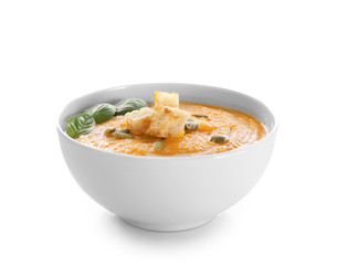 Bowl with delicious carrot soup on white background