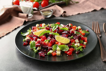 Plate with fresh beet salad on table