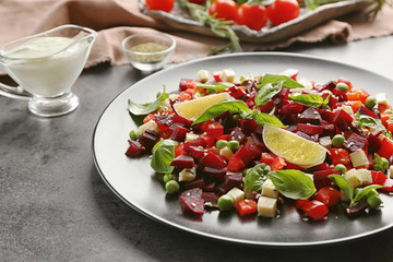 Plate with fresh beet salad on table