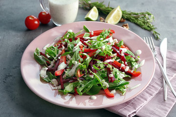 Plate with fresh beet salad on table