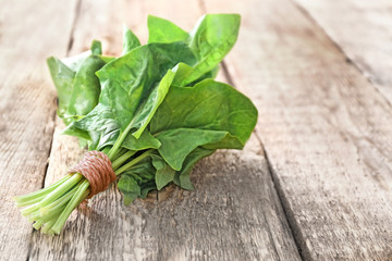 Fresh spinach bunch on wooden background