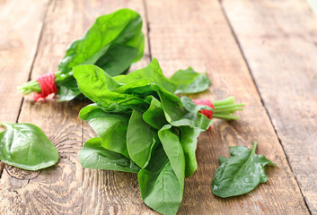Fresh spinach bunches on wooden background