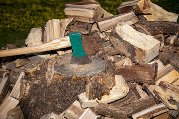 heap of chopped wood, close up on the axe