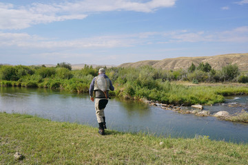 Fototapeta na wymiar Fly fisherman fishing in river of Montana state