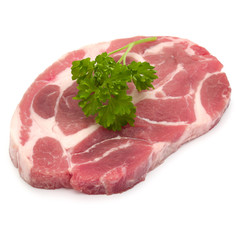 Raw pork neck chop meat with parsley herb leaves garnish isolated on white background cutout