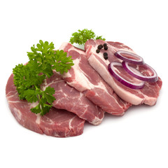 Raw pork neck chop meat with parsley herb leaves, peppercorn spices and onion slices garnish isolated on white background cutout