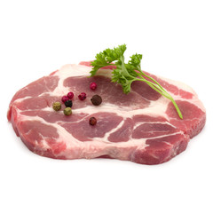 Raw pork neck chop meat with parsley herb leaves and peppercorn spices garnish isolated on white background cutout