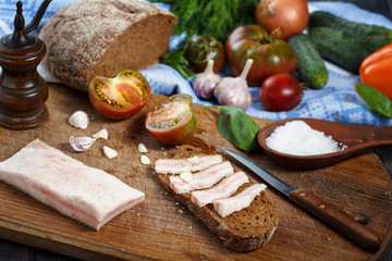 Homemade salo with rye bread on the table. Cured pork fat.