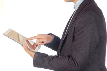 Young man in business suit clicks on tablet screen isolated on white background.