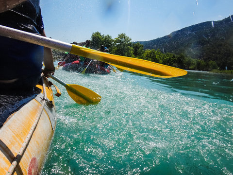 Paddle, river and the side of the boat during rafting