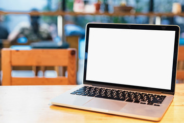 Close up blank screen laptop with clipping path place on the wooden table in coffee shop.