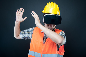 Constructor wearing vr goggles gesturing with hands