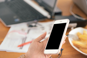 Close up of Asian women's hands holding cell telephone with blank copy space scree for your advertising text message or promotional content, Concept : working, meeting, study, education in coffee shop