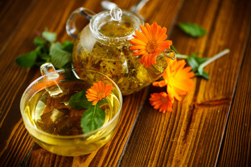 Fototapeta na wymiar Therapeutic tea from flowers of calendula