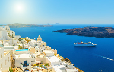 Beautiful panoramic view from touristic Fira town to caldera and volcano at summer sunny day....