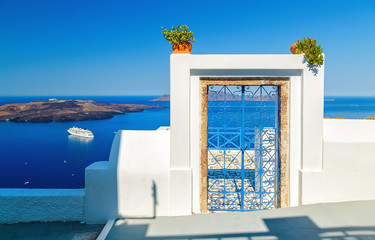 Traditional blue door on Santorini Island, Greece, with view over volcanic caldera and cruise ship