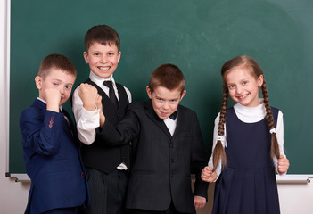 group pupil as a gang, posing near blank chalkboard background, grimacing and emotions, friendshp...